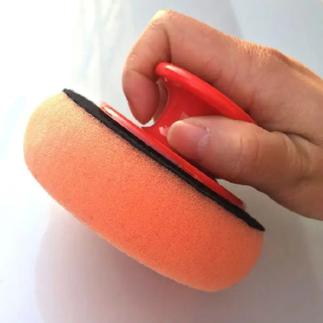 a person using a sponge to clean a surface