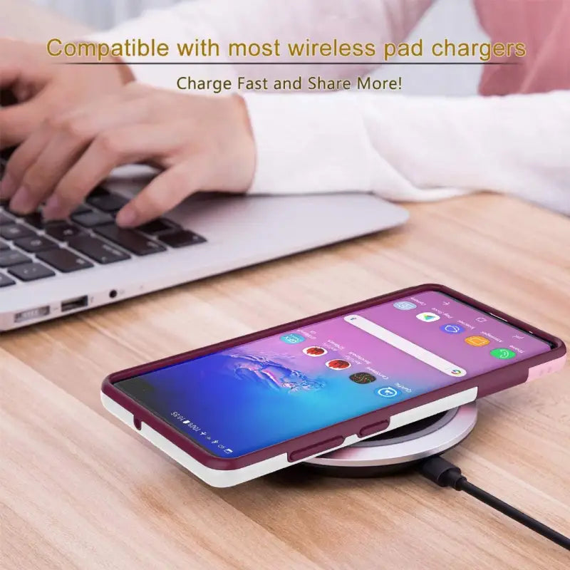 a person using a wireless charger on a laptop