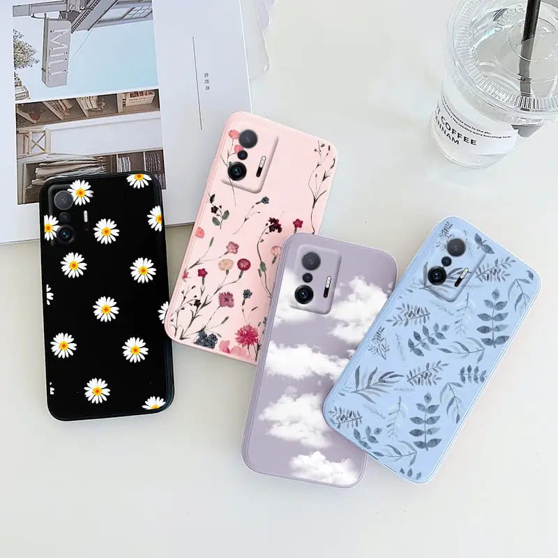 a phone case with flowers and clouds on it
