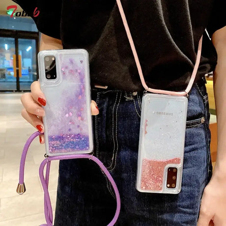 someone holding a phone case with a purple cord attached to it