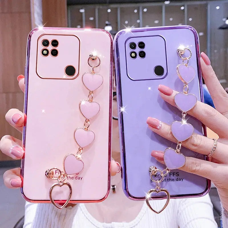 two phone cases with heart charms
