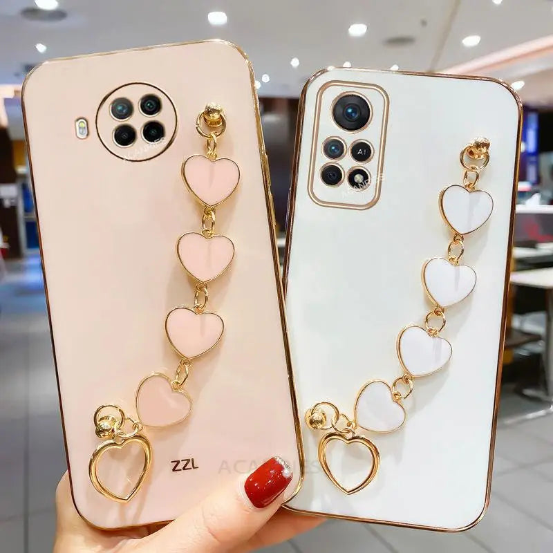 two phone cases with heart charms