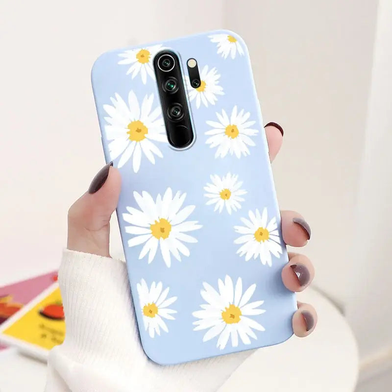 Someone holding a phone with a flower pattern on it