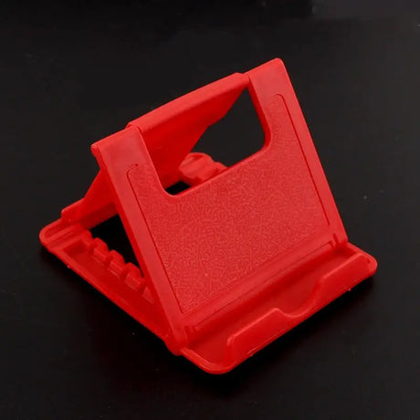 a red plastic phone holder on a black background
