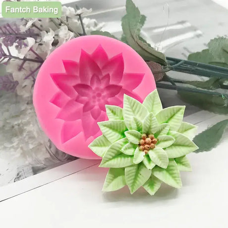 a pink flower shaped cookie cutter next to a green flower