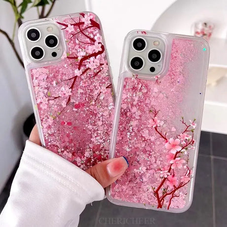 a woman holding a pink phone case with pink flowers