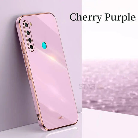 the iphone case is pink and has a blue circle on it