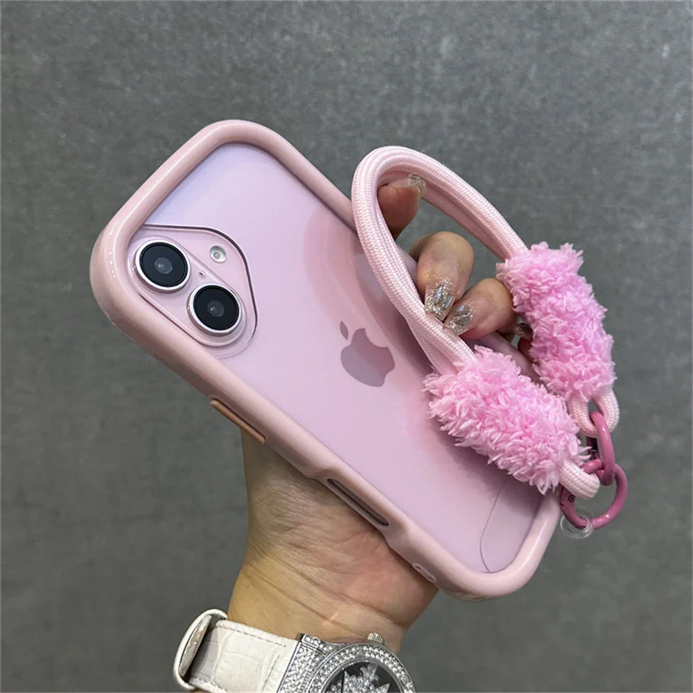 Pink iPhone in a fuzzy case.
