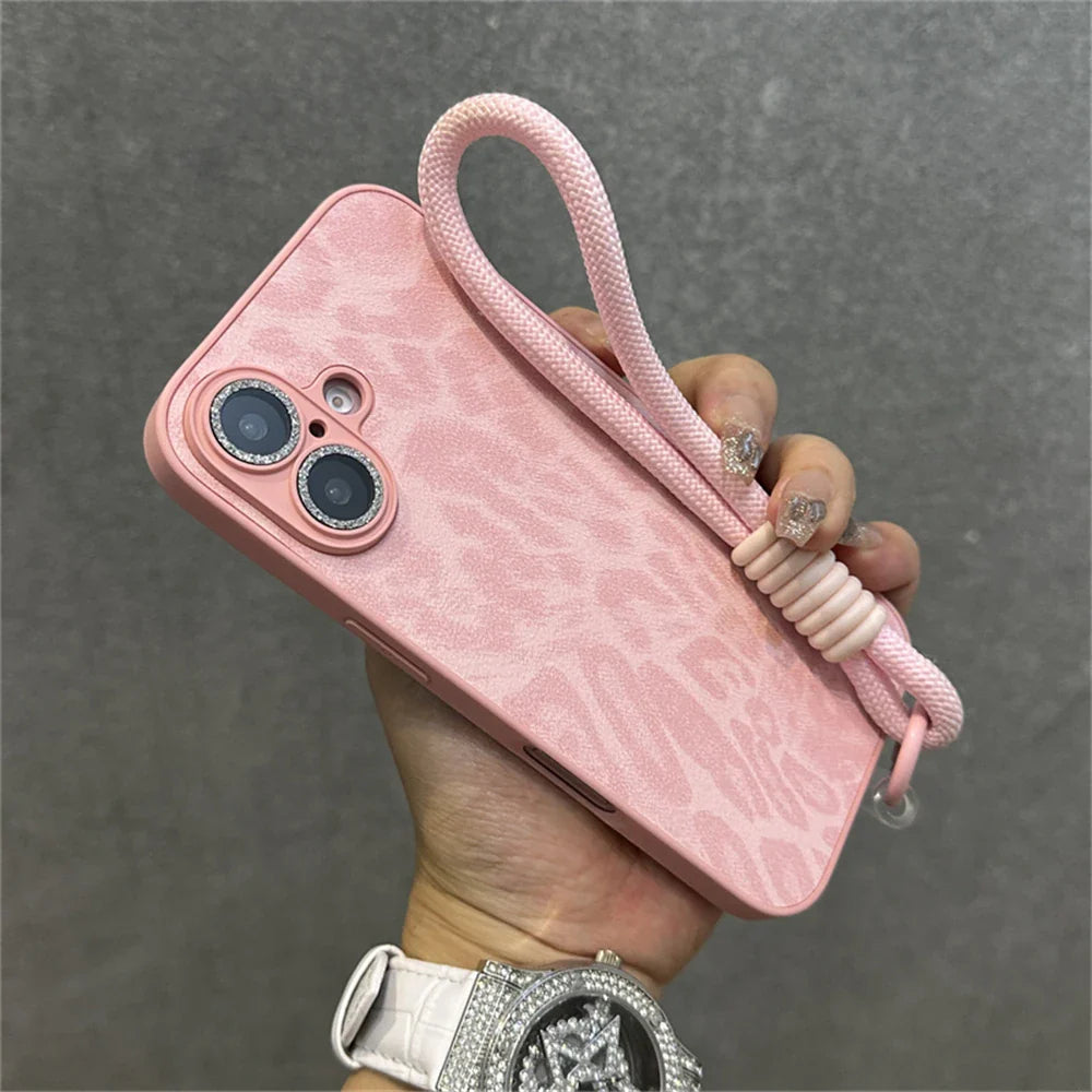Pink leopard-print phone case with wrist strap.