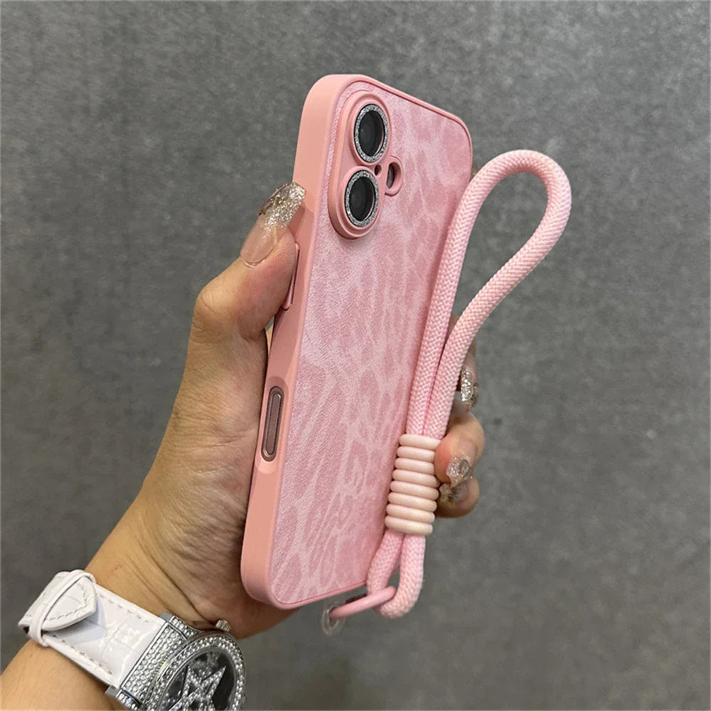 Pink leopard print phone case with wrist strap.