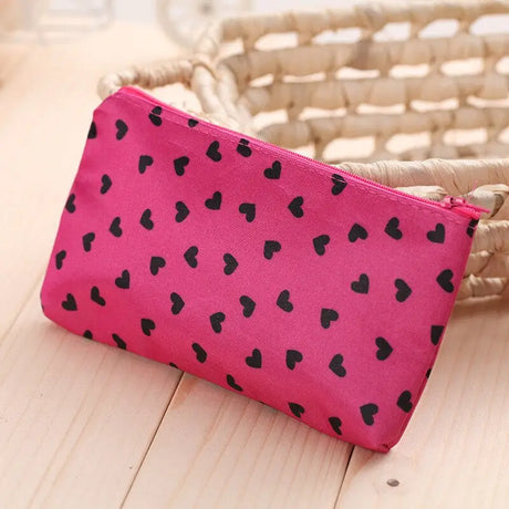 a pink and black heart print purse bag