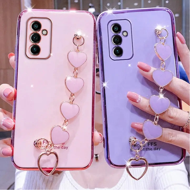 Pink and purple phone cases with heart charms.