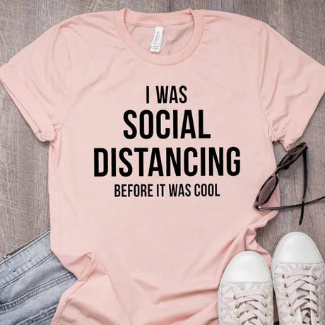 a pink shirt with the words ` was social distaning before i’m’s cool