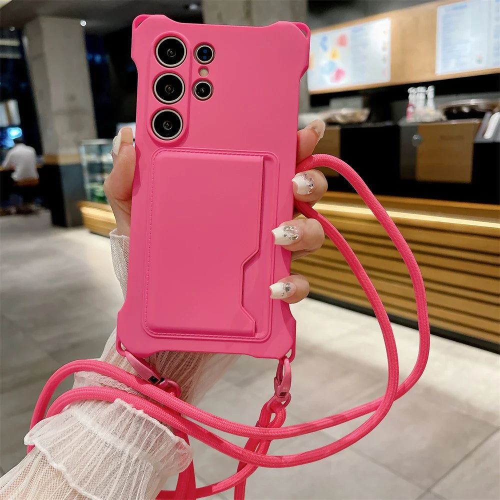Pink smartphone case with a card slot and an attached lanyard.