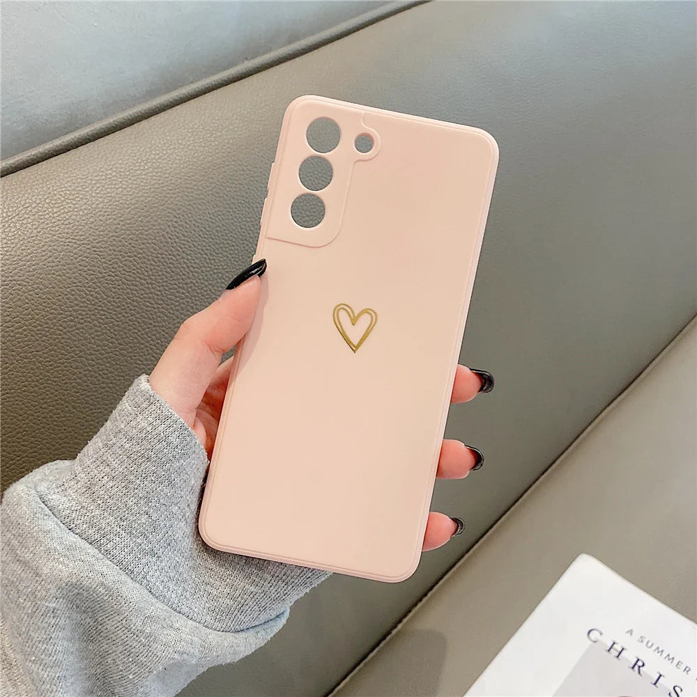 Pink smartphone case with a gold heart design