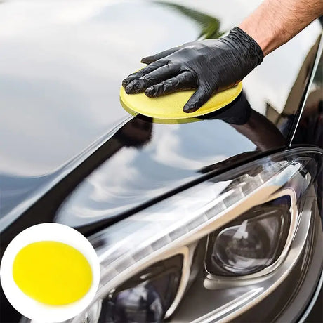 a man polishing a car with a sponge