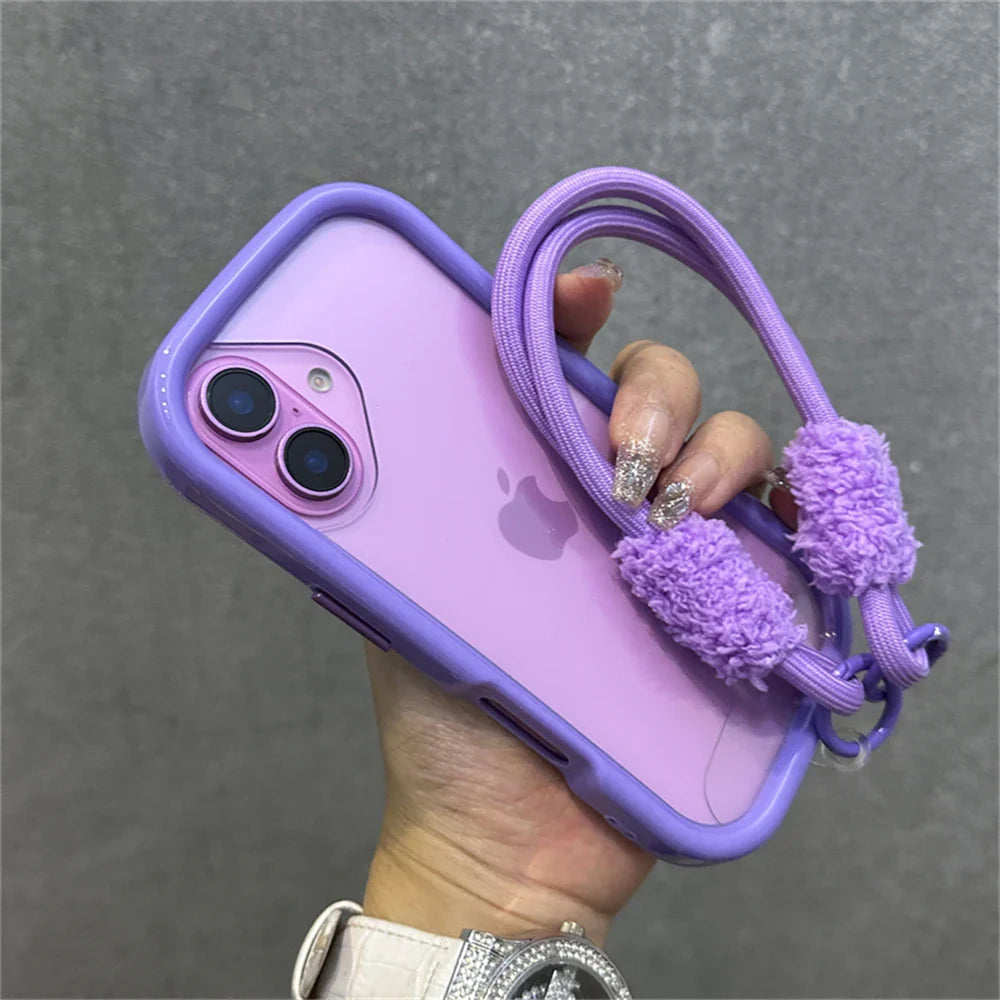 Purple iPhone in a matching case with a fuzzy strap.
