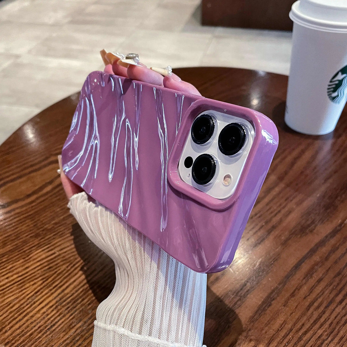Purple phone case with glossy white streaks.