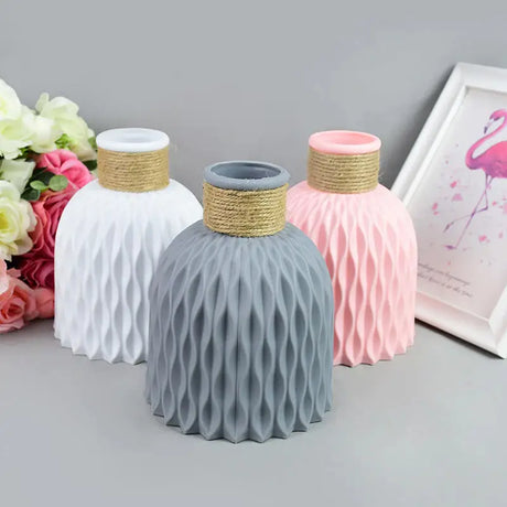 three vases with pink and grey flowers
