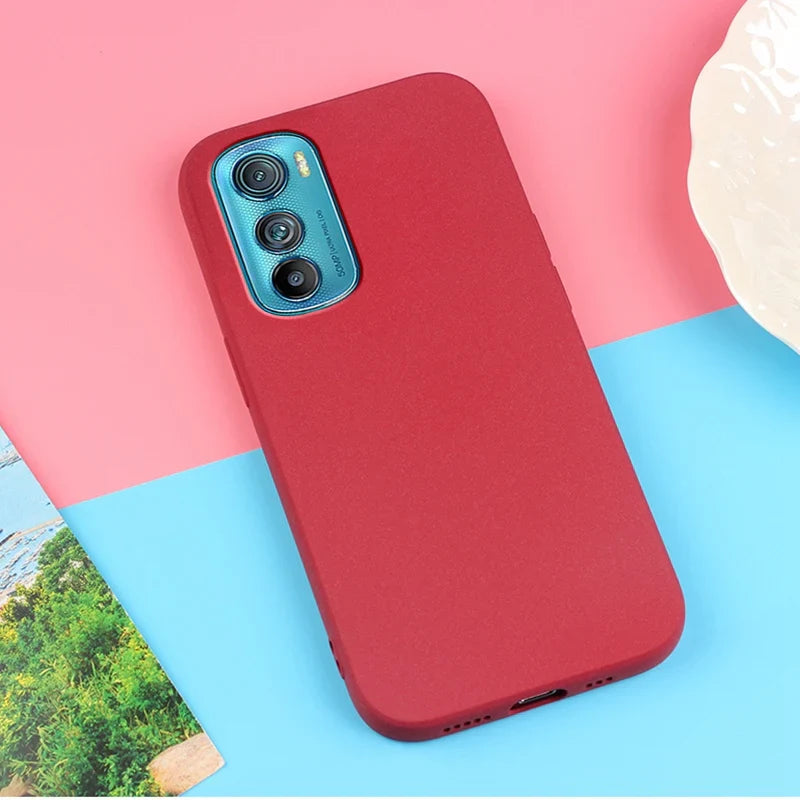 Red smartphone in a protective case.