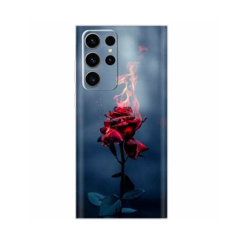 a red flower with fire on it in the dark