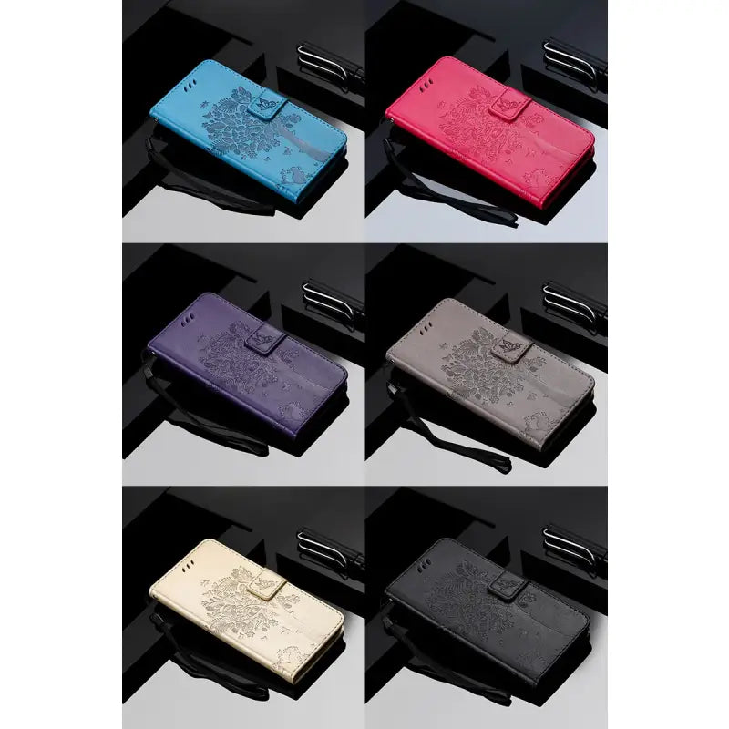 A set of four different colored leather wallets