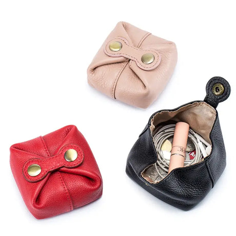 three small leather purses with a small ring