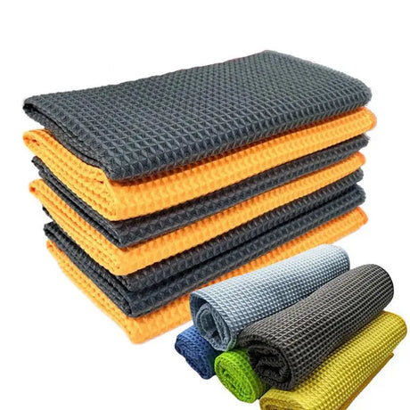 a stack of four different colored towels sitting on top of each other