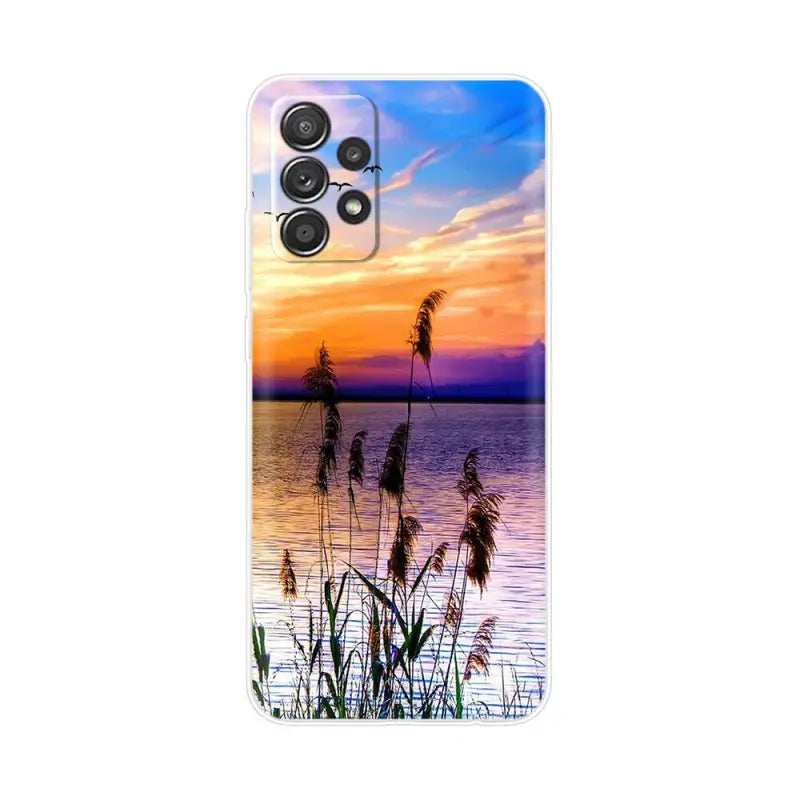 a sunset over the water with a palm tree in the fore