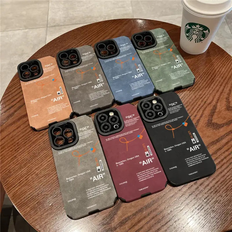 A table with six starbucks coffees and a cup