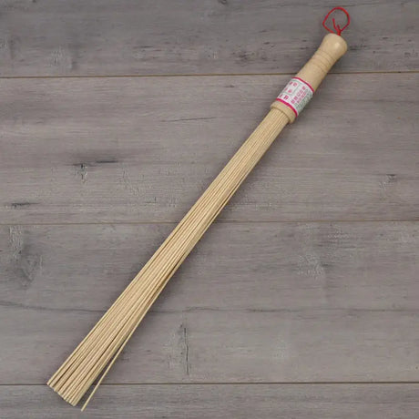 a wooden stick with a red string on it