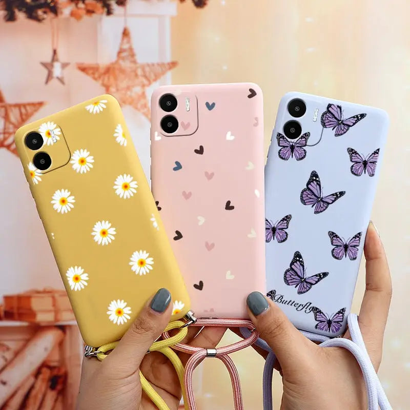 a woman holding two cases with butterflies on them