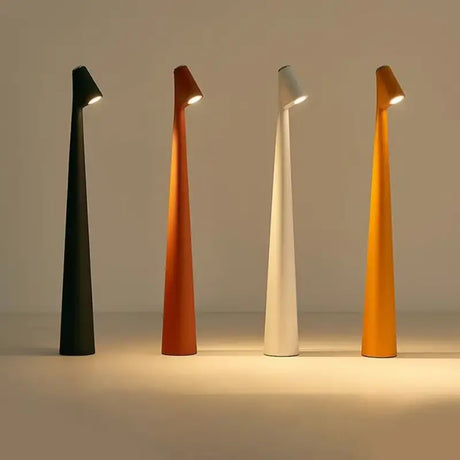 three different colored lamps on a white surface