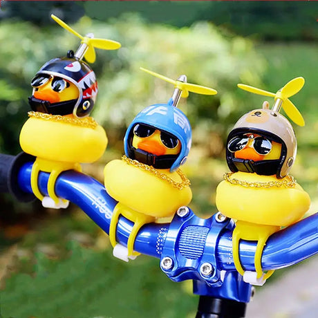 three ducks on a bike with a yellow helmet