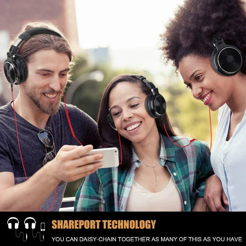 Three smiling people wearing headphones and looking at a smartphone together.