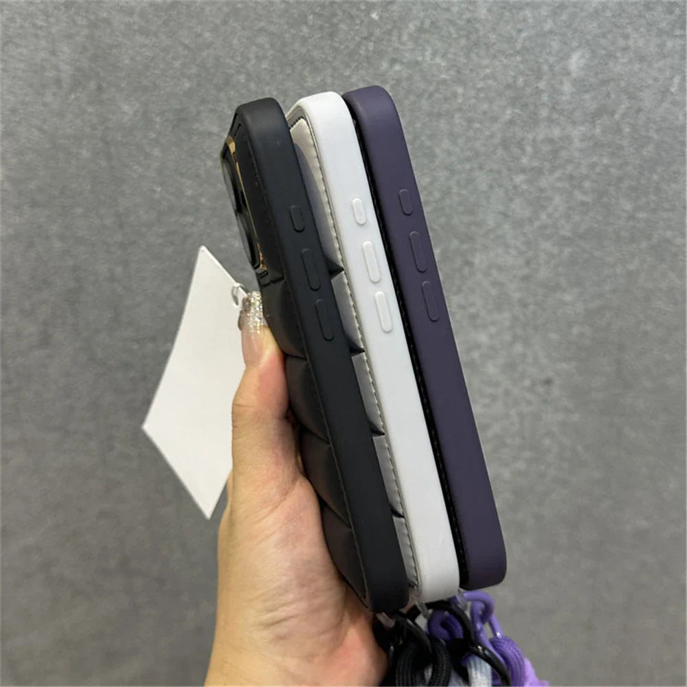 Three phone cases in black, white, and purple.