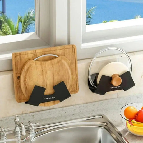 a kitchen sink with a cutting board and a bowl of fruit