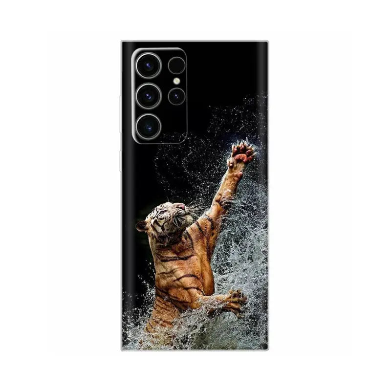 a tiger jumping in the water with its paw