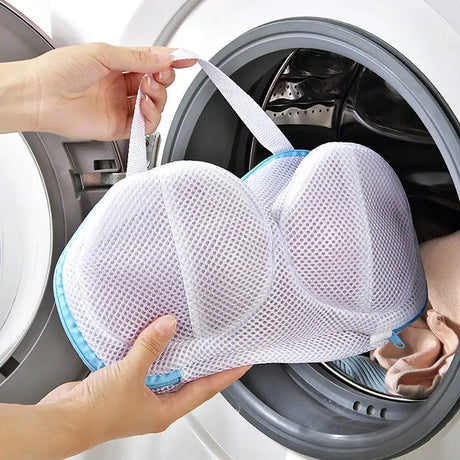 a person putting a cloth into a washing machine