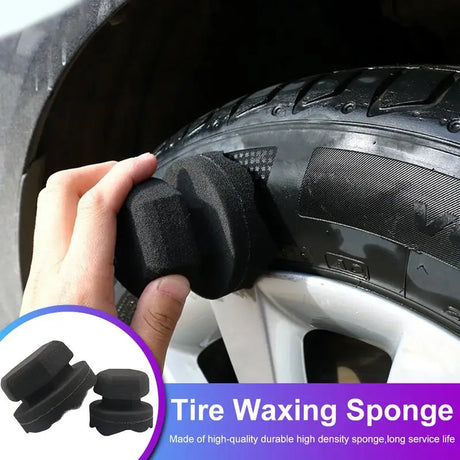 a close up of a person holding a tire with a tire waxing sponge
