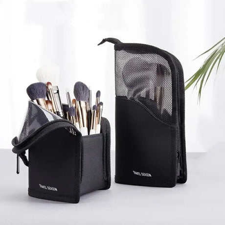 a black makeup brush holder with a brush and brush
