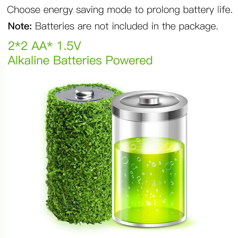 Two AA batteries, one covered in green foliage.
