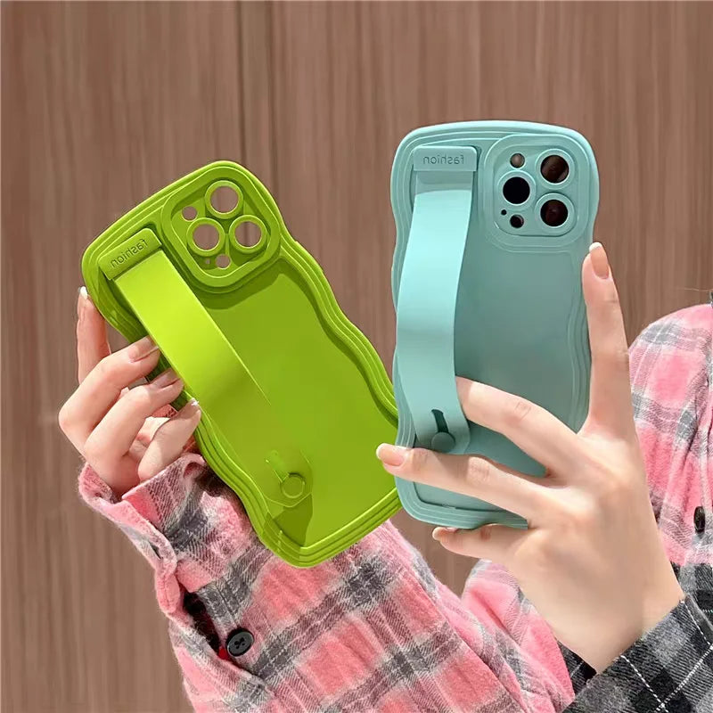 Two colorful phone cases with hand straps.