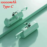 two green plastic pipe holders with a white background