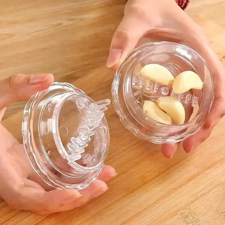 two hands holding two glass jars with a small piece of butter
