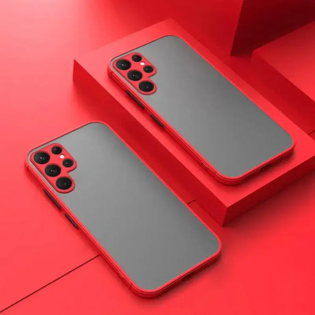 two iphones on a red surface