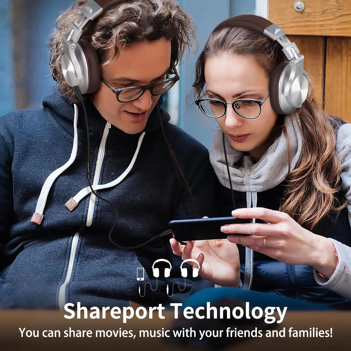 Two people sharing headphones.