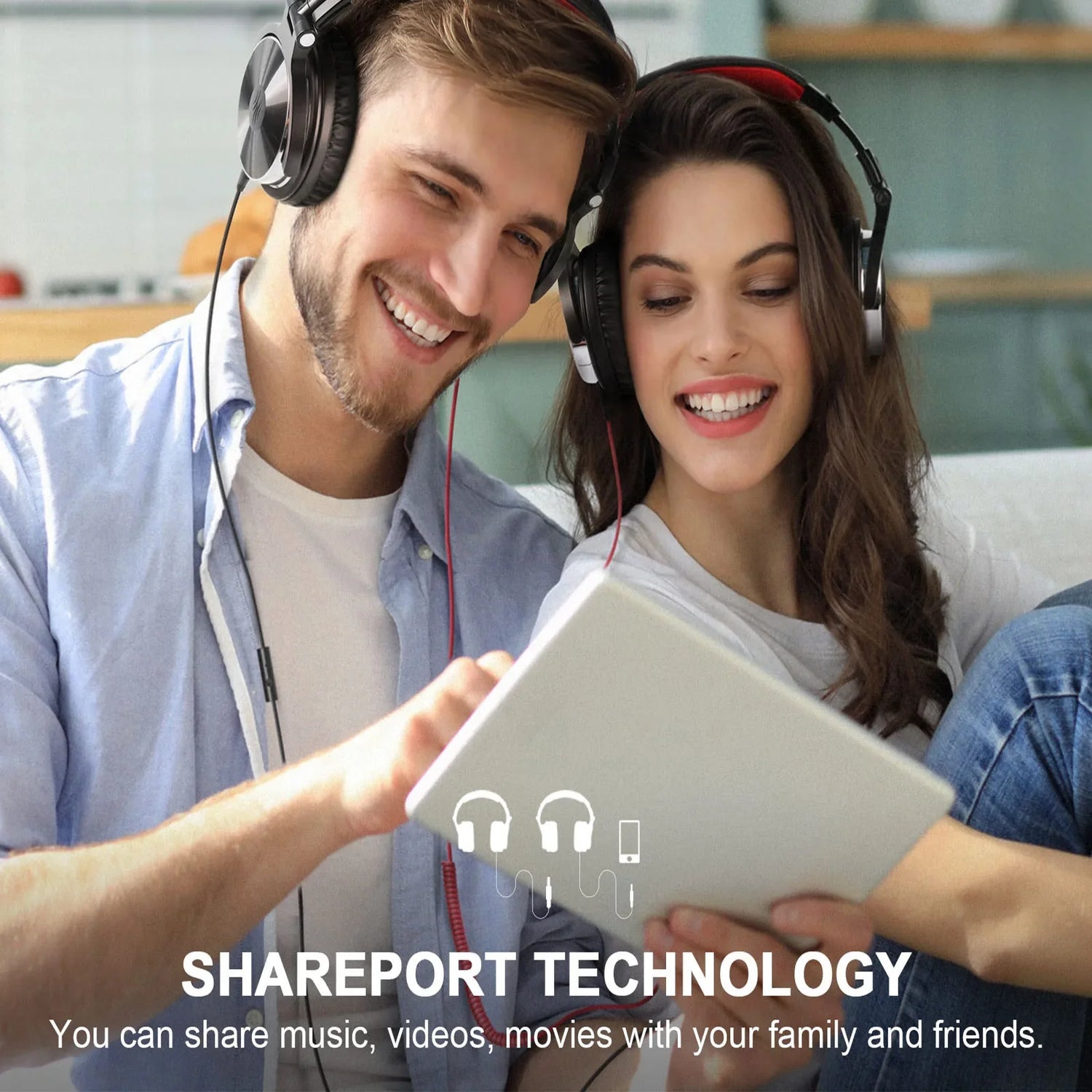 Two people wearing headphones and smiling while looking at a tablet device.