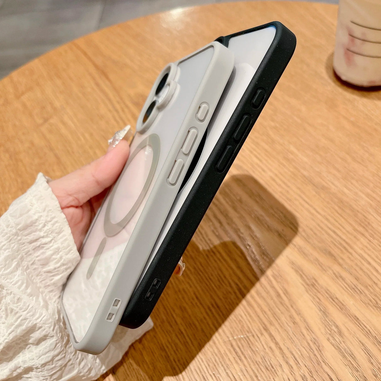 Two phone cases, one gray and one black.