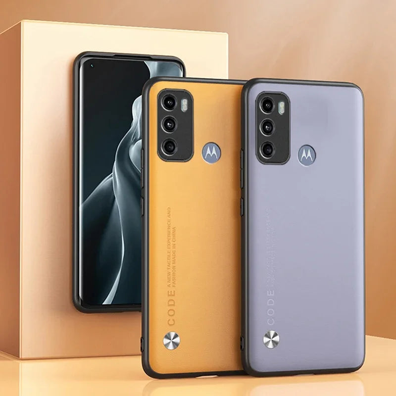 Two smartphones in protective cases, one orange and one purple, with a third phone in the background.